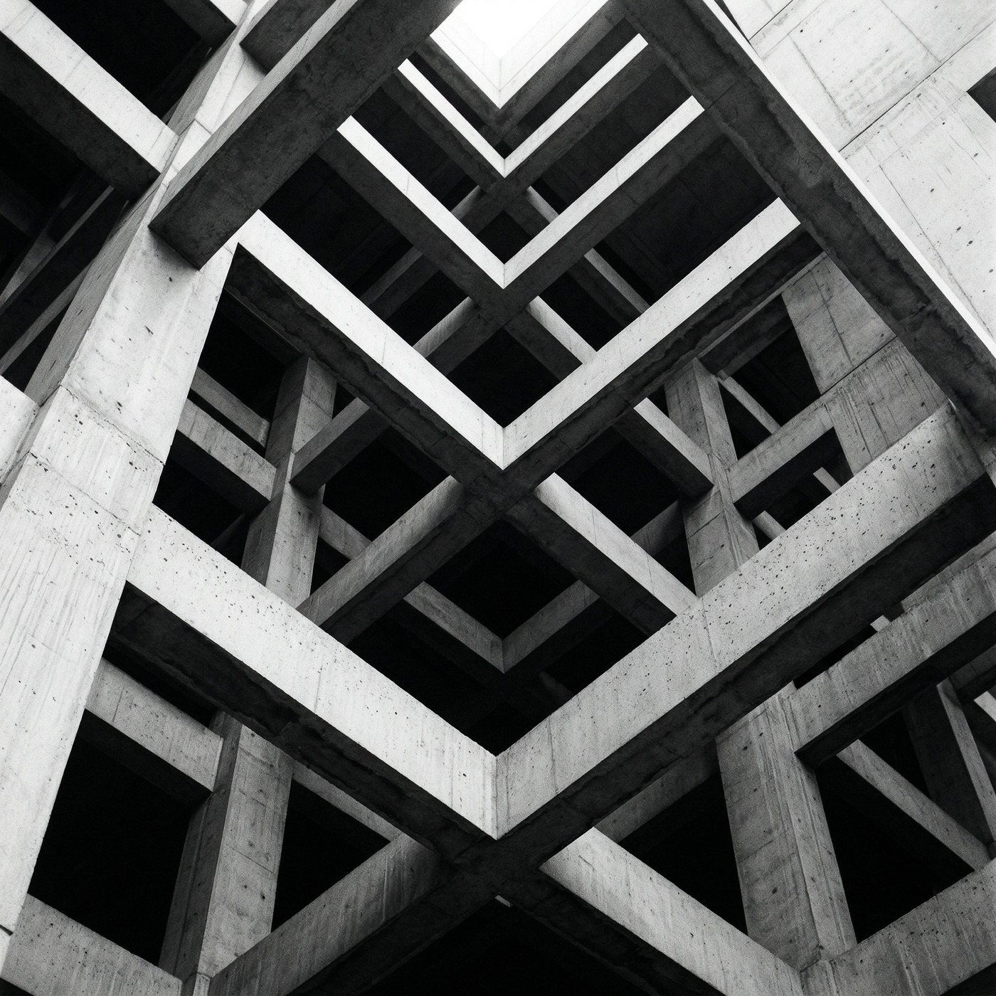 Wide black-and-white documentary photograph of an open-plan studio.